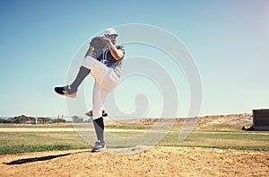 You cant coach this kind of skill. a young man pitching a ball during a baseball match.