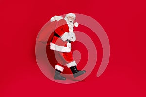 You caught me. Photo portrait of scared impressed santa claus with open mouth carrying big bag of presents isolated on