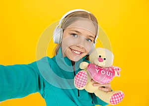 You create my heart smile. Small child hold valentines teddy bear with pink heart. Love you heart inscription. You are