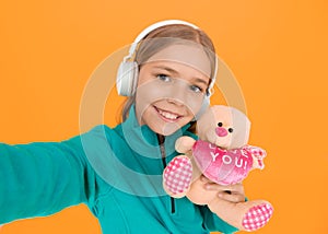 You create my heart smile. Small child hold valentines teddy bear with pink heart. Love you heart inscription. You are