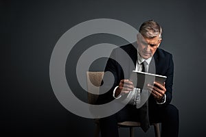 You create your own road map to success. Studio shot of a mature businessman using his digital tablet.