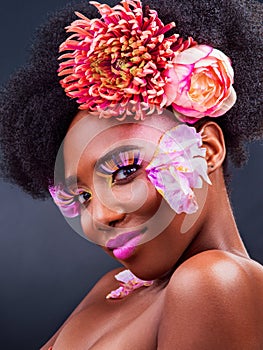 You deserve to feel beautiful. Studio shot of a beautiful young woman posing with flowers in her hair.