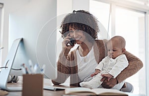 You dont have to pick between parenthood and your profession. a young woman using a smartphone and computer while caring