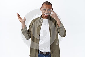 Are you dumb or what. Portrait of arguing annoyed and frustrated african-american man pointing left at disappointing