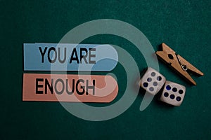 You Are Enough write on a sticky note isolated on Office Desk