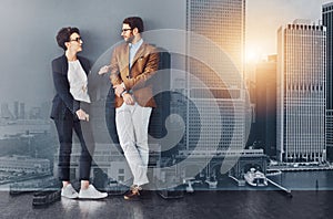 You gain so much from mingling. Full length shot of two designers having a conversation while leaning against a wall.