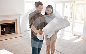 Are you happy with the final plan. Shot of two young architects looking at building plans on site.