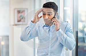 You have horrible timing. a handsome young businessman making a phone call using his smartphone.