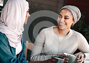 You always have the juiciest stories. two affectionate young girlfriends having a chat at a coffee shop while dressed in