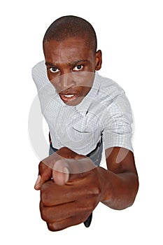 You have the power. High angle studio shot of a young man pointing toward the viewer.