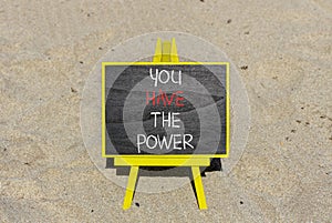 You have the power symbol. Concept word You have the power on beautiful black chalk blackboard. Beautiful sand beach background.
