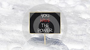 You have the power symbol. Concept word You have the power on beautiful black chalk blackboard. Beautiful white snow background.