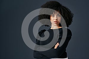 You have to be tough in the business world. a young businesswoman against a studio background.