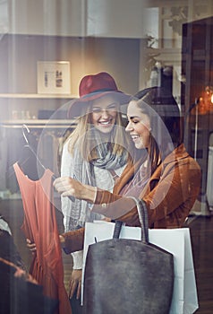 You just have the best style. two best friends out shopping in a clothing store.