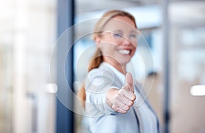 You just keep getting better. Portrait of a mature businesswoman showing thumbs up in a modern office.