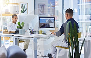 You know how to reach us. Shot of two men working on their computers in a modern office.