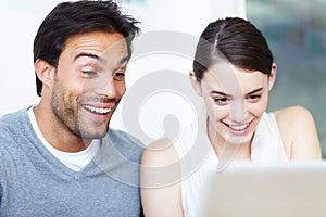 You learn something new every day. A handsome man and a beautiful young woman working together on a laptop.