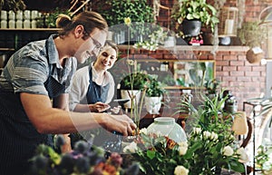 You learn something new everyday when youre working with plants. two young florists watering flowers and working