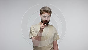 You lie to me! Bearded man suspecting falsehood, touching nose doing liar gesture and pointing at camera