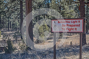 Before You Light It, Prepare To Fight It, sign. Overheard, Navajo County, Sitgreaves National Forest, Arizona USA