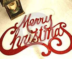 Red Merry Christmas sign, with candle lantern to light the way photo