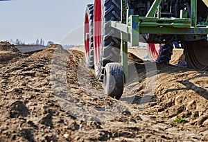 You look past a tractor at an asparagus field in Germany.