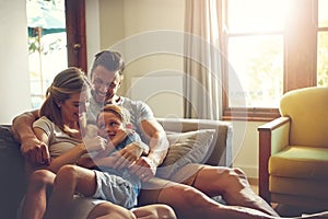 When you love what you have, youve everything you need. a family of three spending some quality time at home.