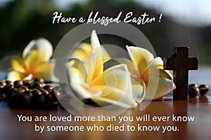 You are loved by Someone who died for you. Have a blessed Easter. Happy Easter day concept with love message & wooden rosary beads photo