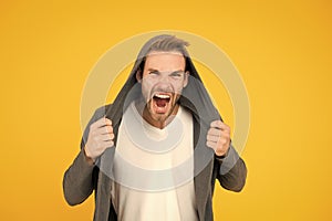 You make me angry. Angry man yellow background. Handsome guy in angry mood. Unshaven model scream with anger. Negative