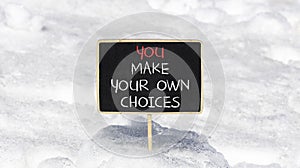 You make your own choice symbol. Concept words You make your own choice on beautiful blackboard. Beautiful snow background.