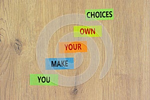 You make your own choice symbol. Concept words You make your own choice on colored paper. Beautiful wooden background. Business