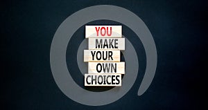 You make your own choice symbol. Concept words You make your own choice on wooden blocks. Beautiful black table black background.