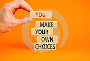You make your own choice symbol. Concept words You make your own choice on wooden blocks. Beautiful orange background. Businessman