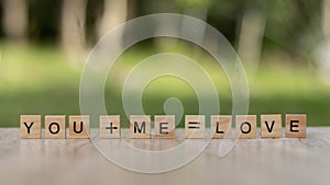 You and me word Written With wood Blocks On table nature background