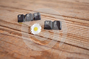 You and me wrote with keyboard keys on wooden background