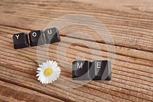 You and me wrote with keyboard keys on wooden background