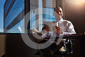 You must always be able to predict whats next...a young man contemplating while using his digital tablet.