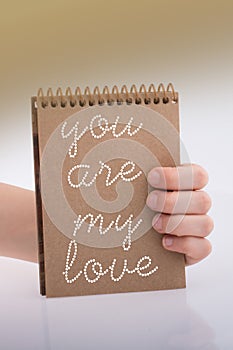 You are my love text on notebook in hand as love cocept