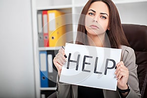 European tired and frustrated woman working as secretary in stress at work business district office desk with computer laptop ask