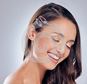 You never outgrow fun hair clips. Shot of an attractive young woman standing alone in the studio and posing.