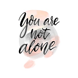 You are not alone. Support quote. Inspirational saying, handwritten calligraphy text on abstract pink and gray