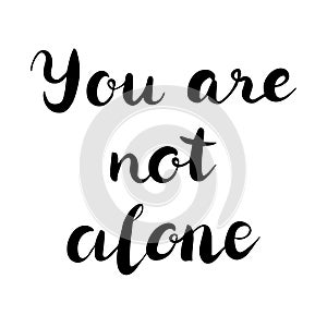 You are not alone text. Brush calligraphy. Vector isolated illustration.