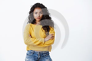 You are out of my league. Sassy confident alluring young curly-haired woman in yellow t-shirt cross arms chest and photo