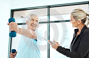 You're are doing better each day. Shot of a physiotherapists helping her senior patient with his exercises in a