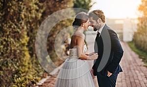 You;re my wife now. Shot of a happy young couple standing together on their wedding day.