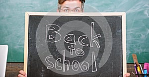 Are you ready study. Teacher or school principal welcomes inscription back to school. Teacher peeking out blackboard