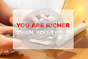 YOU ARE RICHER THAN YOU THINK - motivational text on the background of a working person from home