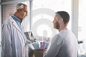 You seem to be recovering well. a senior doctor giving his male patient a thorough checkup during his consultation.