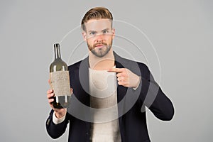 You should try this. Man holds bottle alcohol drink. Social and cultural aspects of drinking. Businessman formal suit