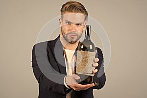 This is for you. Social and cultural aspects of drinking. Businessman formal suit confidently welcomes grey background